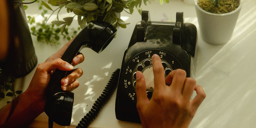image of a person dialling a phone