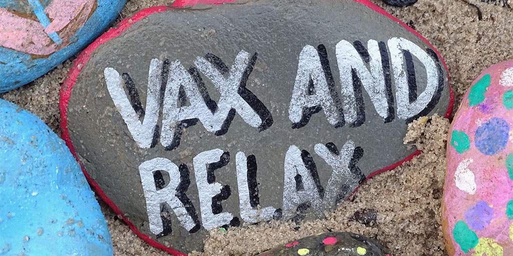 image of a rock with the text vax and relax written on it