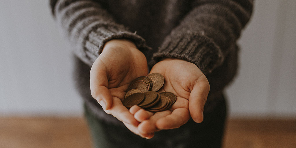 photo of a woman's hands holding out coins