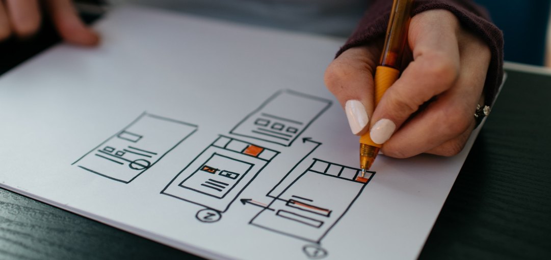 A person sketching a website's UI
