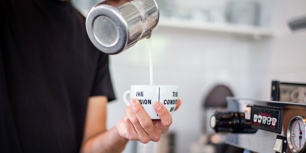 photo of a barista pouring coffee