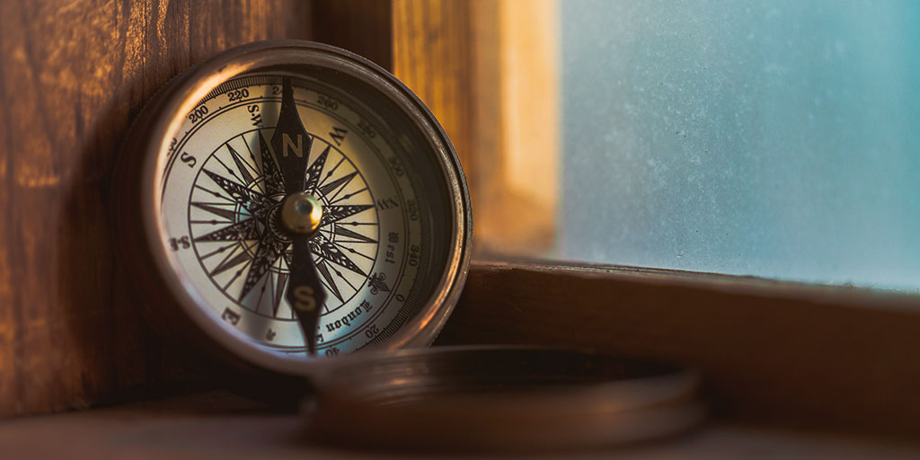 image of a compass placed on a window sill