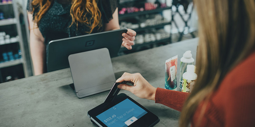 image of a customer paying by card at a shop