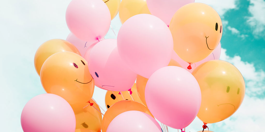 image of a bunch of baloons with smiley faces on them