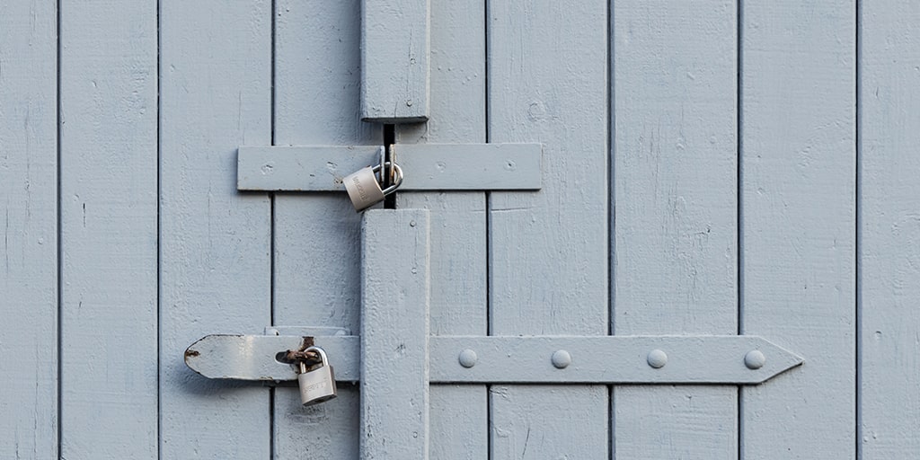 photo of two padlocks on a wooden door