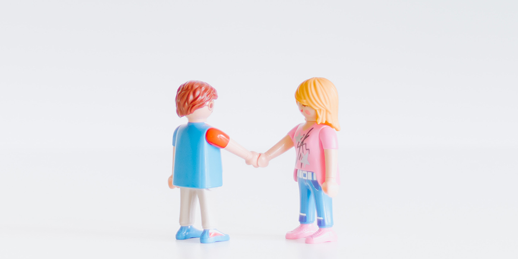 Photo of two lego figures shaking hands